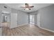 This bedroom features wood-look floors, a ceiling fan, and a door to the outside at 1501 Oscar Ct # 101, Las Vegas, NV 89146