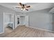 Bedroom featuring wood-look floors, a ceiling fan, and access to the bathroom and kitchen at 1501 Oscar Ct # 101, Las Vegas, NV 89146