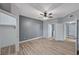 Bedroom featuring wood-look floors, a ceiling fan, a closet, and a door to the bathroom at 1501 Oscar Ct # 101, Las Vegas, NV 89146