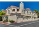 Charming townhome with private garages, red tile roof, and stucco facade on a sunny day at 1501 Oscar Ct # 101, Las Vegas, NV 89146