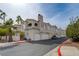 Exterior of a home with an attached garage and mature landscaping with palm trees at 1501 Oscar Ct # 101, Las Vegas, NV 89146
