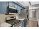 Close-up of kitchen with quartz countertops and stainless steel appliances at 1501 Oscar Ct # 101, Las Vegas, NV 89146