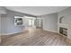 Bright, open-concept living room featuring a fireplace and wood-look flooring at 1501 Oscar Ct # 101, Las Vegas, NV 89146