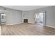 Bright living room features wood floors, a cozy fireplace, and sliding glass doors to the patio at 1501 Oscar Ct # 101, Las Vegas, NV 89146