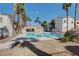 Inviting community pool surrounded by palm trees and lush landscaping on a sunny day at 1501 Oscar Ct # 101, Las Vegas, NV 89146