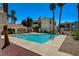 The pool area features a clear blue pool, lounge chairs, and beautiful landscaping at 1501 Oscar Ct # 101, Las Vegas, NV 89146