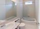 Bright bathroom featuring a bathtub, toilet, and sink at 1569 Hialeah Dr, Las Vegas, NV 89119