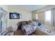 Bedroom with neutral walls and tones and a queen-size bed and various furnishings at 1569 Hialeah Dr, Las Vegas, NV 89119