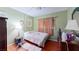 Relaxing bedroom featuring hardwood floors, a comfortable bed, and a tranquil ambiance at 1569 Hialeah Dr, Las Vegas, NV 89119