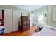 Cozy bedroom with hardwood floors, closet, and a comfortable bed with soft lighting at 1569 Hialeah Dr, Las Vegas, NV 89119