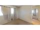 Bedroom with neutral walls and carpet, window with curtains and doorway to another room at 1569 Hialeah Dr, Las Vegas, NV 89119