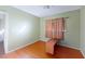 Bright bedroom with hardwood floors, window, and a desk at 1569 Hialeah Dr, Las Vegas, NV 89119