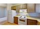 Kitchen with white appliances and wood cabinets at 1569 Hialeah Dr, Las Vegas, NV 89119