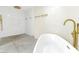 Modern bathroom featuring a separate shower and bathtub, gold fixtures, and sleek design at 1679 Raindance Way, Las Vegas, NV 89169