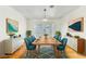 Bright dining room featuring a wooden table with seating for six, stylish decor and plenty of natural light at 1679 Raindance Way, Las Vegas, NV 89169