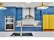 The modern kitchen features custom cabinets, stainless appliances, and bright lighting at 1679 Raindance Way, Las Vegas, NV 89169
