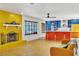A bright and open concept living space with a partial kitchen view at 1679 Raindance Way, Las Vegas, NV 89169