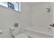 Bathroom featuring a step-up soaking tub with shower and window at 1808 Piccolo Way, Las Vegas, NV 89146