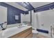Bright bathroom featuring a shower over the tub and single sink vanity at 1808 Piccolo Way, Las Vegas, NV 89146