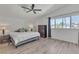 Bright bedroom with vaulted ceiling, ceiling fan, natural light and wood-look laminate flooring at 1808 Piccolo Way, Las Vegas, NV 89146