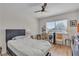 Cozy bedroom featuring a ceiling fan and a large window with natural light at 1808 Piccolo Way, Las Vegas, NV 89146