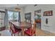 Dining area with hardwood floors featuring a wooden table and natural light at 1808 Piccolo Way, Las Vegas, NV 89146