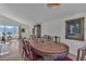 Hardwood floors lead to a dining room featuring a wooden table, chairs, and natural light at 1808 Piccolo Way, Las Vegas, NV 89146