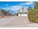 Two-story home featuring an attached two-car garage, an arched gated entrance and a xeriscaped front yard at 1808 Piccolo Way, Las Vegas, NV 89146