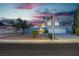 Charming two-story home with a two-car garage and desert landscaping at dusk at 1808 Piccolo Way, Las Vegas, NV 89146