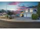 Two story home at dusk with front yard landscaping and a two car garage at 1808 Piccolo Way, Las Vegas, NV 89146