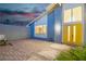Inviting home exterior featuring a spacious brick patio and a bright yellow door at 1808 Piccolo Way, Las Vegas, NV 89146