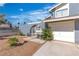 Home featuring an arched gated entrance leading to a yellow door and an attached two-car garage at 1808 Piccolo Way, Las Vegas, NV 89146