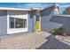 Eye-catching home with a gray exterior, large window, and vibrant yellow front door at 1808 Piccolo Way, Las Vegas, NV 89146