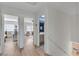Upstairs hallway features doorways to bathroom, bedroom, and home office with modern flooring at 1808 Piccolo Way, Las Vegas, NV 89146