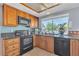 Kitchen features stainless appliances, tile backsplash, and view of backyard at 1808 Piccolo Way, Las Vegas, NV 89146
