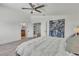 Spacious main bedroom featuring white bedding, ceiling fan, ensuite bathroom and dressing room at 1808 Piccolo Way, Las Vegas, NV 89146