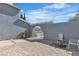 Home's gated side patio featuring a brick paver patio and low maintenance plants at 1808 Piccolo Way, Las Vegas, NV 89146