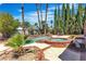 Backyard pool featuring beautiful palm trees and a bricked in hot tub at 1808 Piccolo Way, Las Vegas, NV 89146