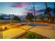 Pool and hot tub area bordered by desert landscaping and trees in backyard at 1808 Piccolo Way, Las Vegas, NV 89146