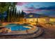 Sparkling backyard pool area with covered patio, fire pit, and desert landscaping at 1808 Piccolo Way, Las Vegas, NV 89146