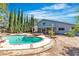 Backyard pool and hot tub combination surrounded by greenery and the house at 1808 Piccolo Way, Las Vegas, NV 89146