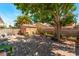 The beautiful backyard features a brick patio, offering a relaxing area surrounded by mature trees and lush landscaping at 1922 Falcon Ridge St, Las Vegas, NV 89142