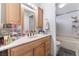 Bathroom featuring a bathtub, vanity, and well-lit mirror at 1922 Falcon Ridge St, Las Vegas, NV 89142