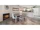 Cozy dining area with a fireplace and a view into the kitchen. Tile floors add a touch of modern flair at 1922 Falcon Ridge St, Las Vegas, NV 89142