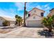 Charming two-story home featuring a two-car garage, desert landscaping, and inviting curb appeal at 1922 Falcon Ridge St, Las Vegas, NV 89142
