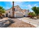 Charming two-story home featuring a two-car garage, desert landscaping, and inviting curb appeal at 1922 Falcon Ridge St, Las Vegas, NV 89142