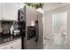 Kitchen featuring stainless steel refrigerator and access to a bathroom at 1922 Falcon Ridge St, Las Vegas, NV 89142