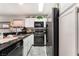 Modern kitchen with stainless steel appliances, granite countertops, and white cabinetry at 1922 Falcon Ridge St, Las Vegas, NV 89142