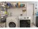 This functional laundry area includes a newer washer and dryer, and a water heater on the left, enhancing daily convenience at 1922 Falcon Ridge St, Las Vegas, NV 89142