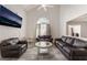 Inviting living room featuring a vaulted ceiling, modern tile floors, and comfortable seating at 1922 Falcon Ridge St, Las Vegas, NV 89142